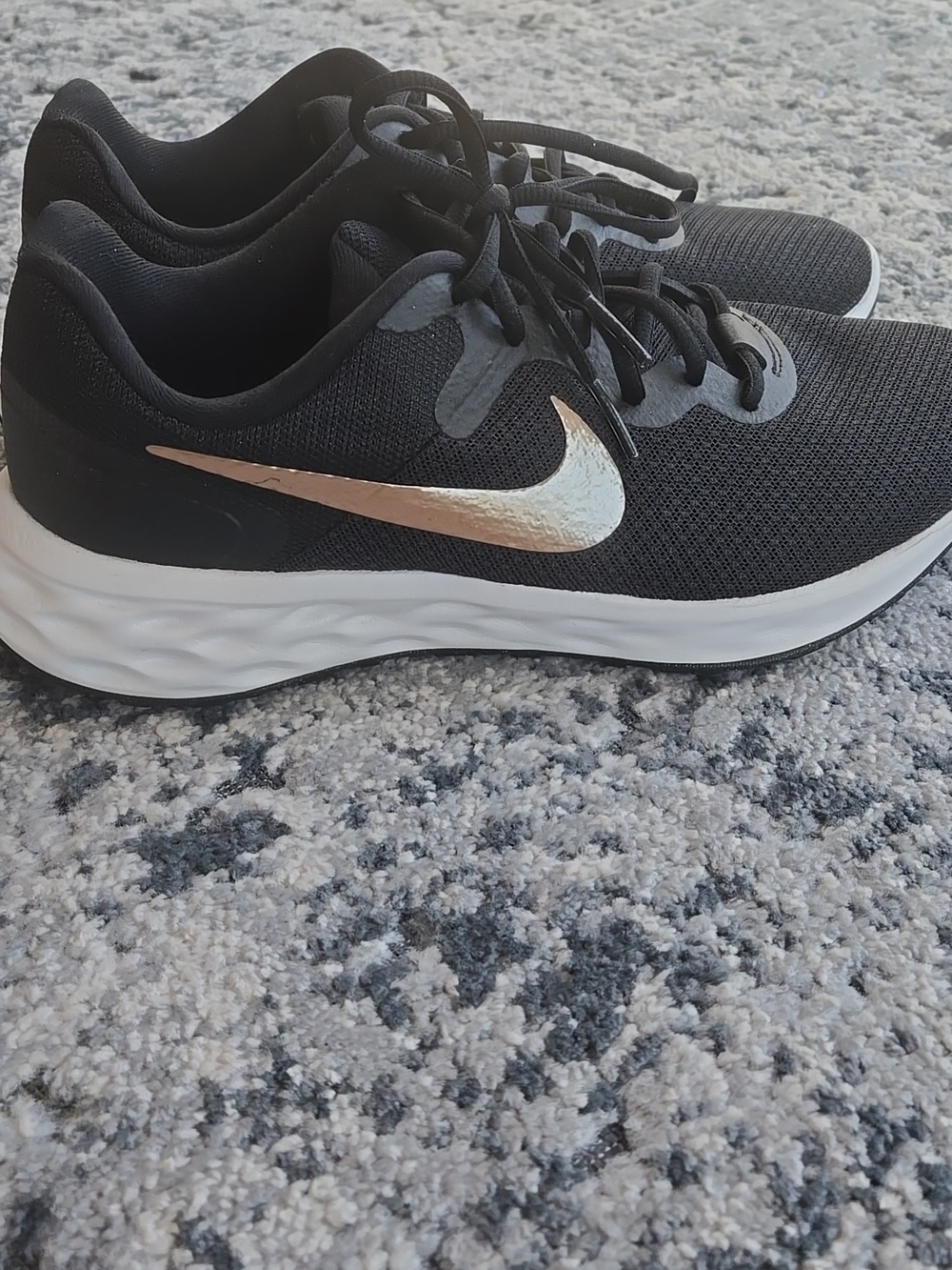 Nike Women's Black Sneakers with Metallic Gold Swoosh
